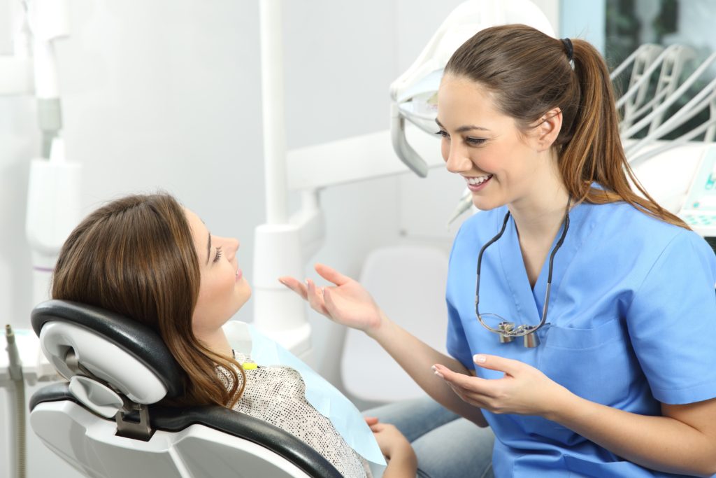 Dentist explaining procedure to a patient dental implants